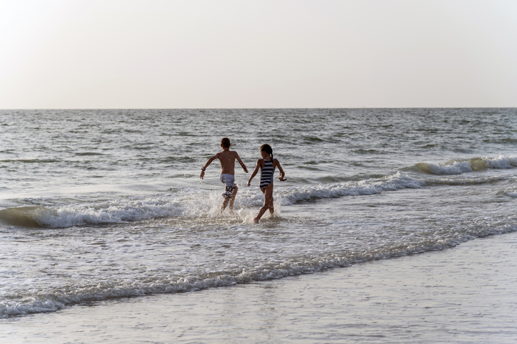 Children run on beach